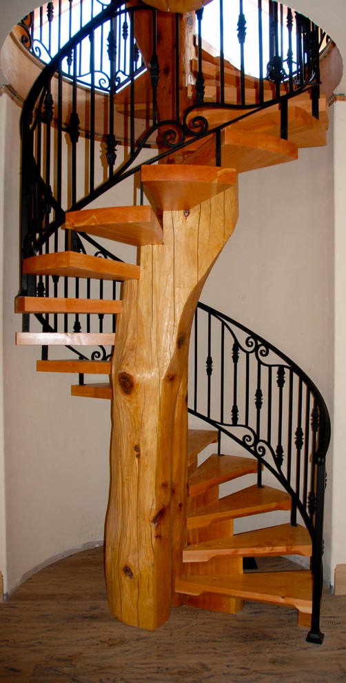 Foto de escalera de caracol rústica con escalones de madera y contrahuellas de madera