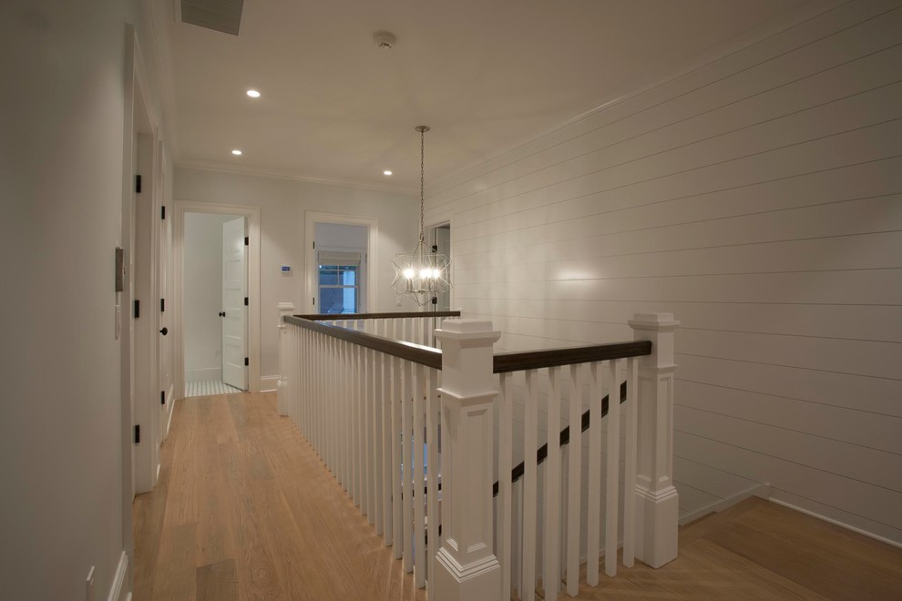 Inspiration for a large farmhouse wood l-shaped wood railing staircase in New York with painted wood risers.