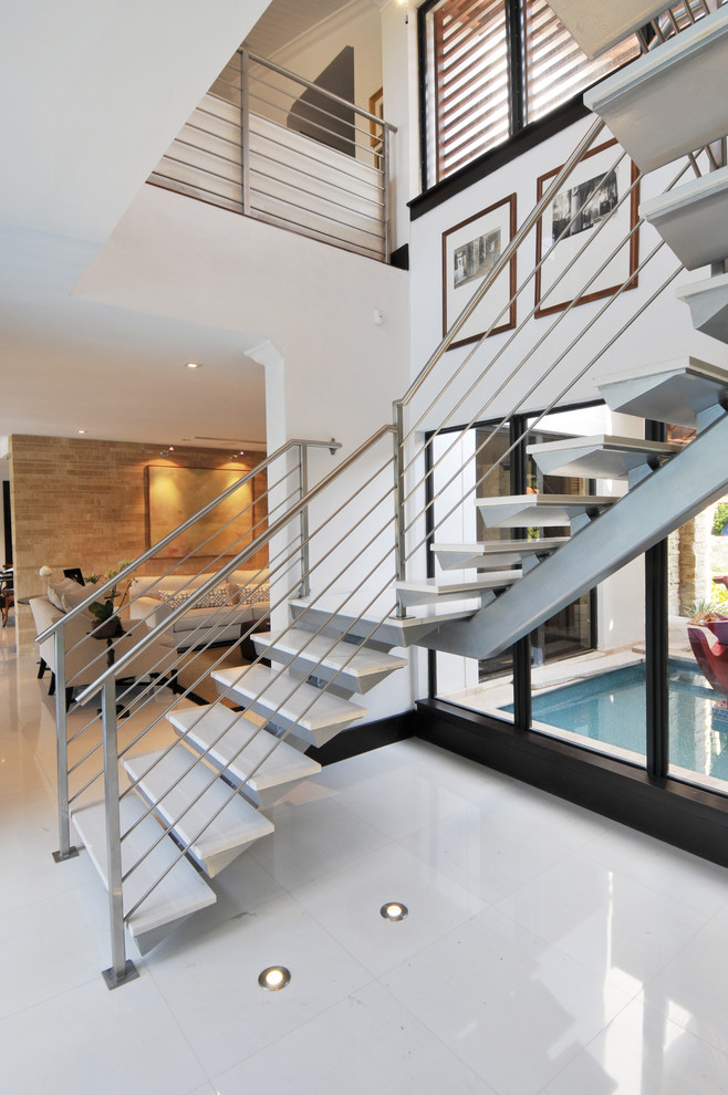 Contemporary l-shaped staircase in Miami with metal risers.