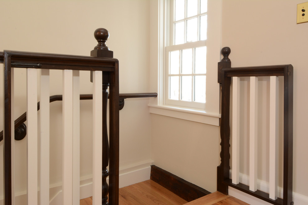 Photo of a large classic wood straight staircase in Boston with wood risers.