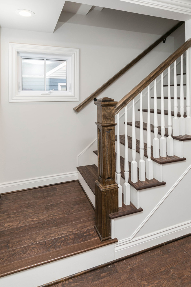 Inspiration for a mid-sized timeless wooden l-shaped wood railing staircase remodel in Detroit with wooden risers