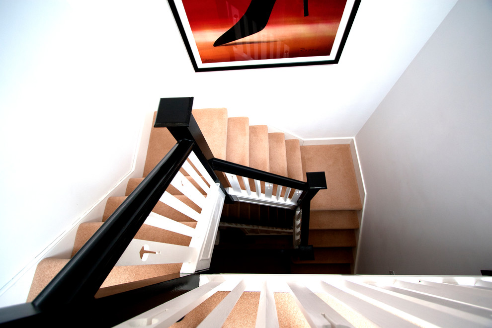 Staircase - mid-sized modern carpeted u-shaped staircase idea in London with carpeted risers