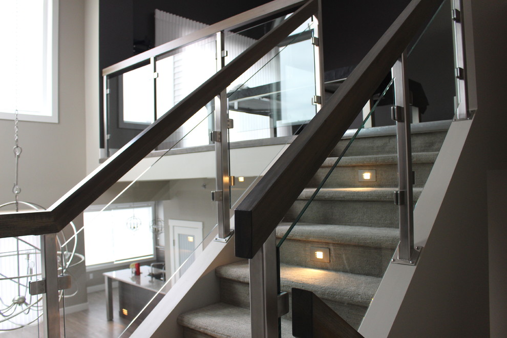 Staircase - mid-sized modern carpeted u-shaped mixed material railing staircase idea in Vancouver with carpeted risers
