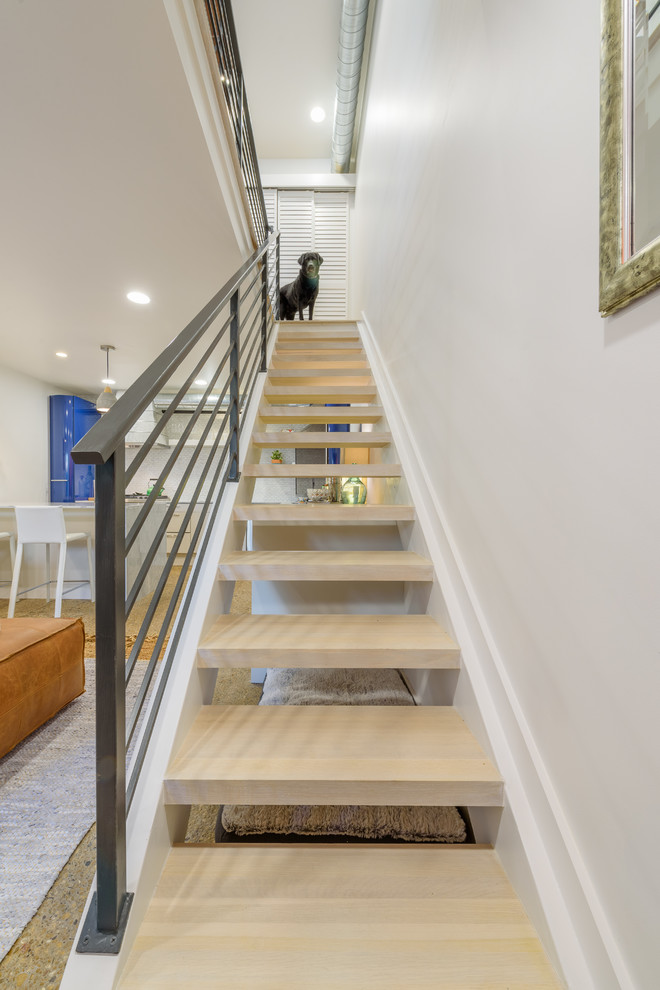 Photo of a small contemporary wood straight metal railing staircase in Dallas with wood risers.