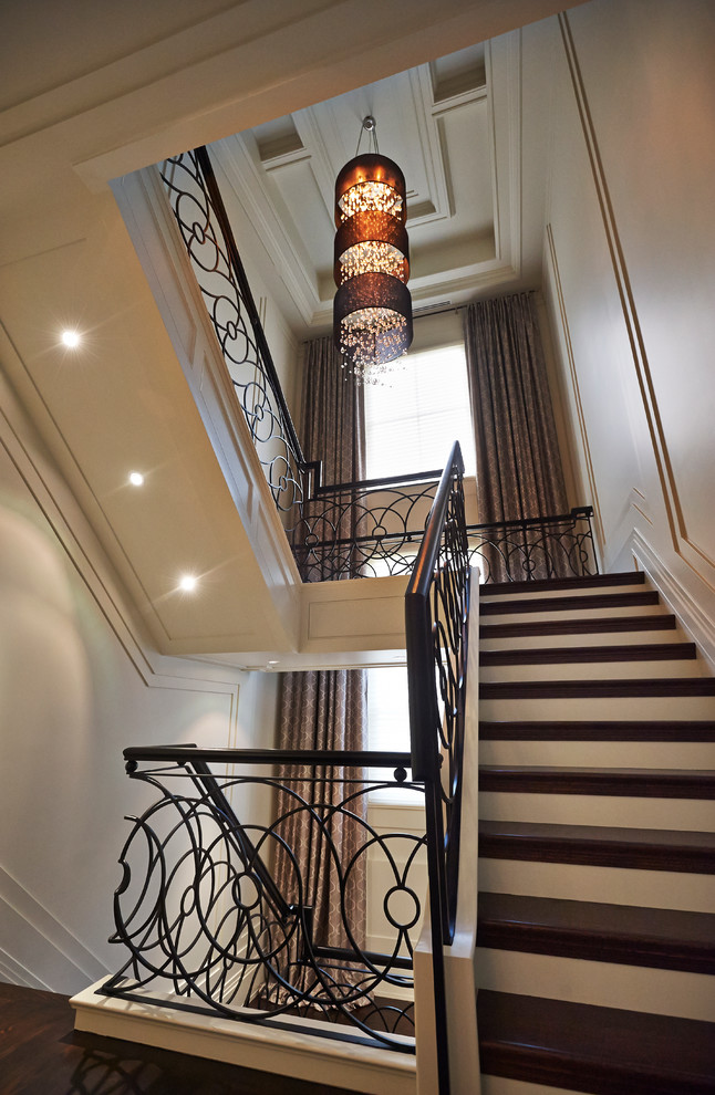 Inspiration for a large classic wood u-shaped staircase in Toronto with painted wood risers.