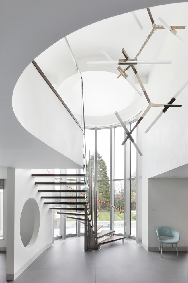 Staircase - huge contemporary wooden curved open staircase idea in London
