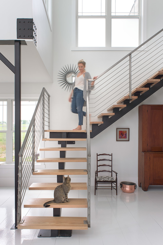 Example of a large transitional wooden l-shaped metal railing staircase design in Other with metal risers