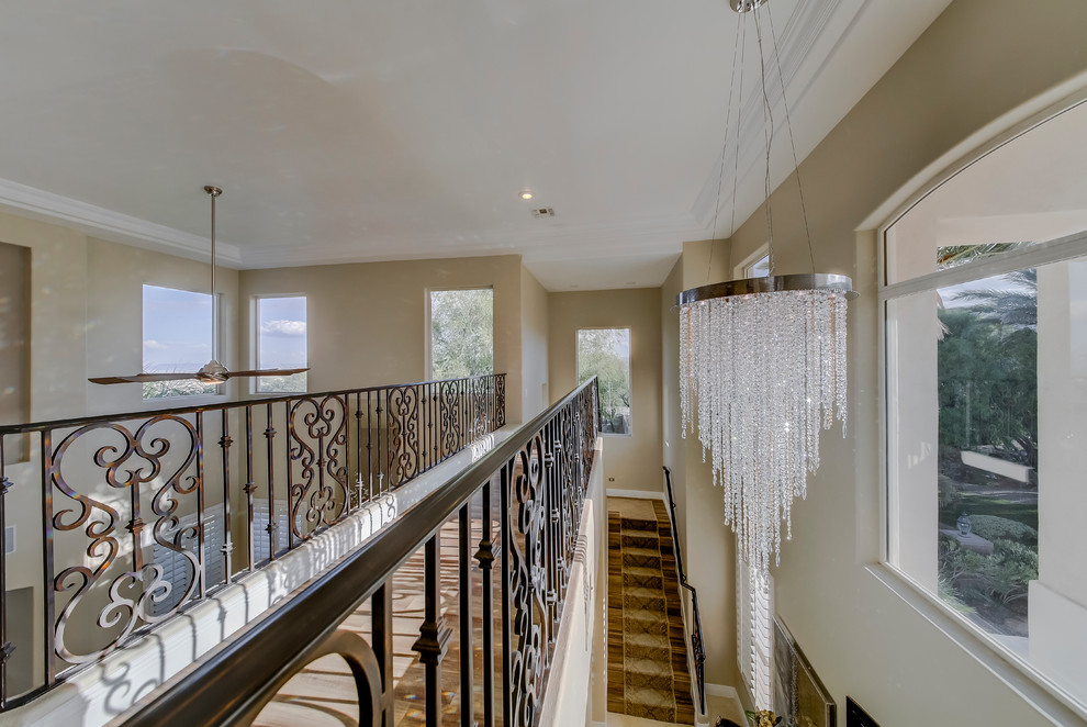Large tuscan wooden straight metal railing staircase photo in Las Vegas with wooden risers