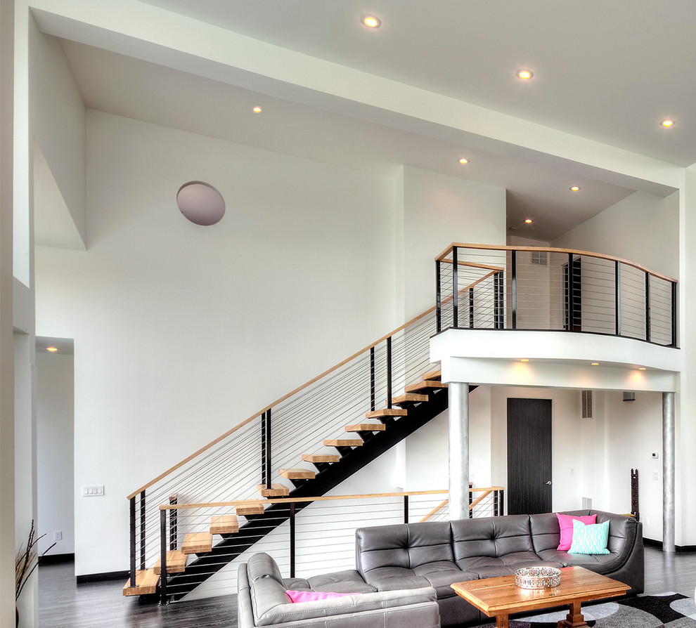 Photo of a large contemporary wood floating staircase in Other with open risers.