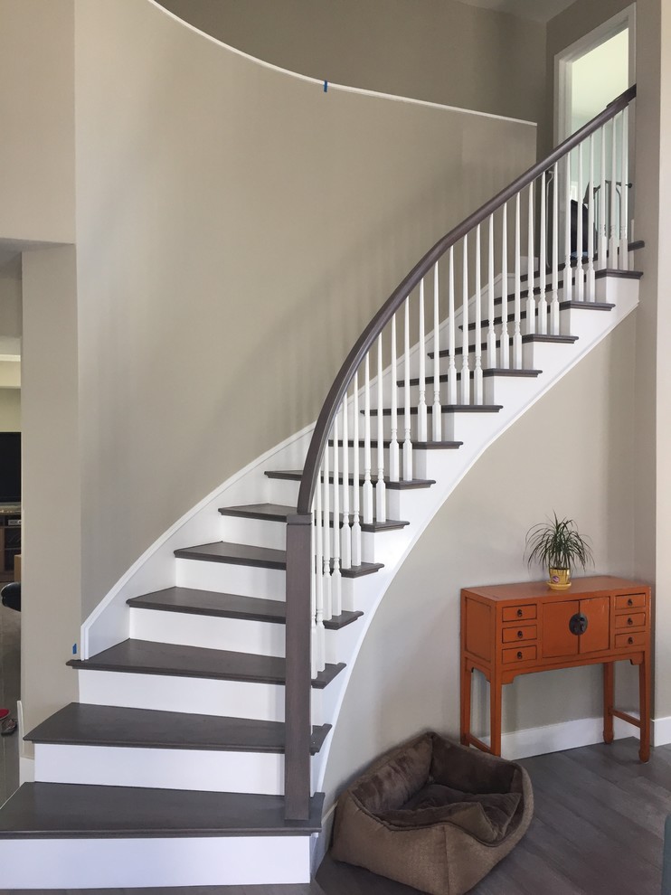 Inspiration for a medium sized contemporary wood curved staircase in Orange County with painted wood risers.