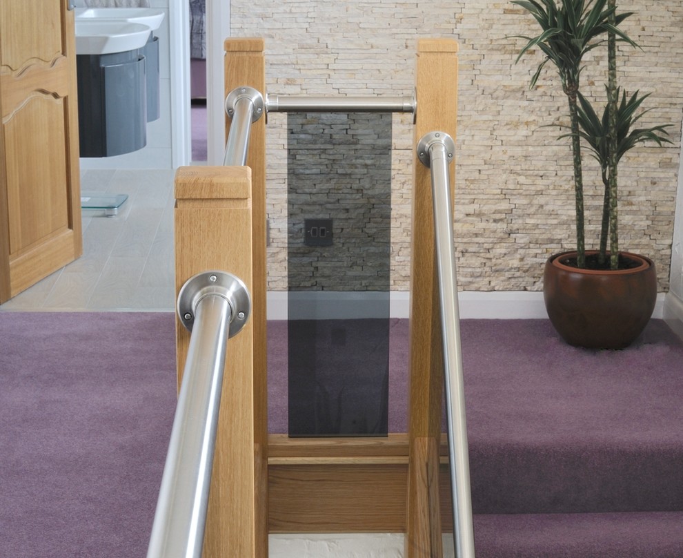 Ejemplo de escalera recta actual de tamaño medio con escalones enmoquetados, contrahuellas de madera y barandilla de madera
