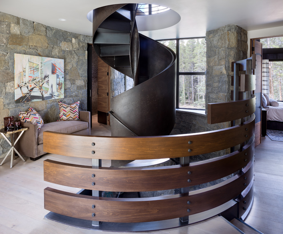 Rustic metal spiral staircase in Denver with metal risers and feature lighting.