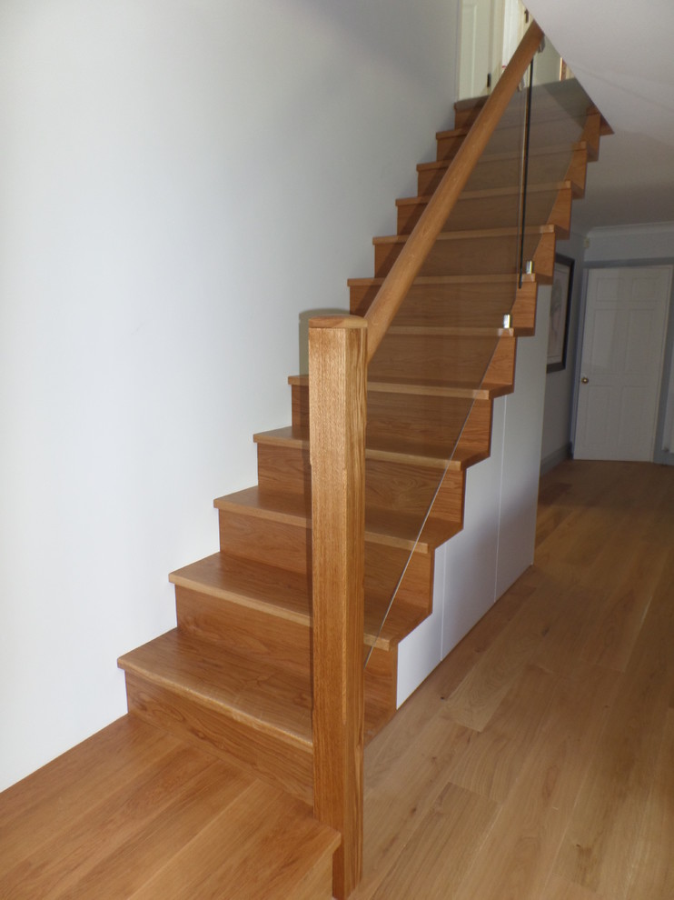 Medium sized contemporary wood l-shaped staircase in London with wood risers.