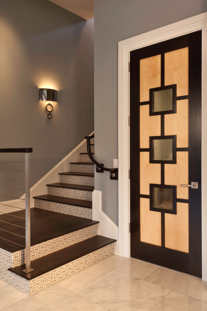 Inspiration for a contemporary wooden staircase remodel in Miami with tile risers