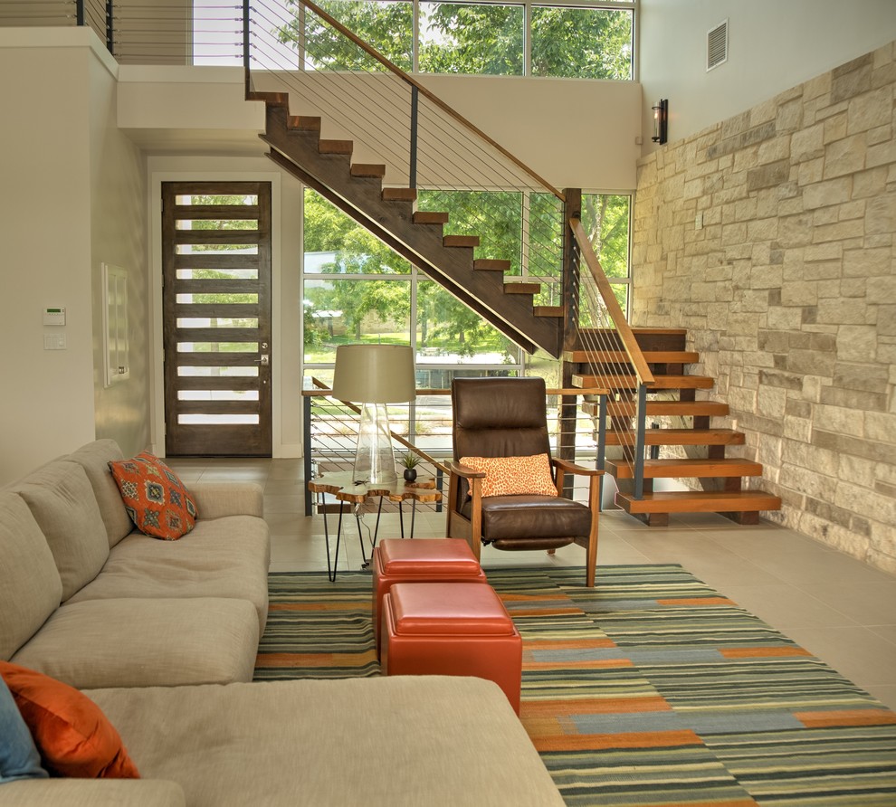Design ideas for a contemporary wood floating staircase in Austin with open risers and feature lighting.