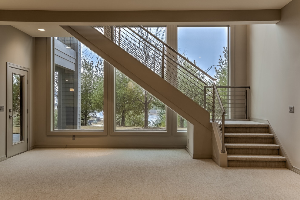 This is an example of a medium sized contemporary carpeted l-shaped staircase in Omaha with carpeted risers.