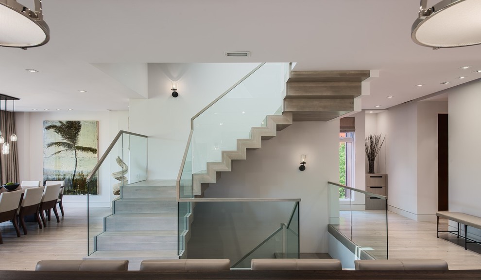 Contemporary wood u-shaped staircase in Miami with wood risers.