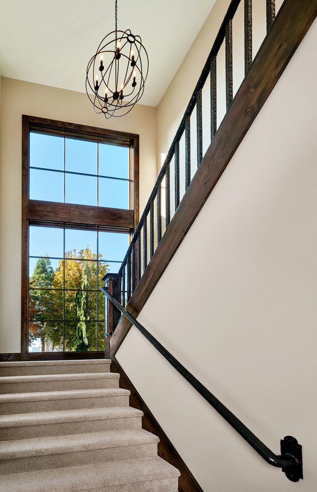 Large farmhouse carpeted metal railing staircase photo in Portland with carpeted risers