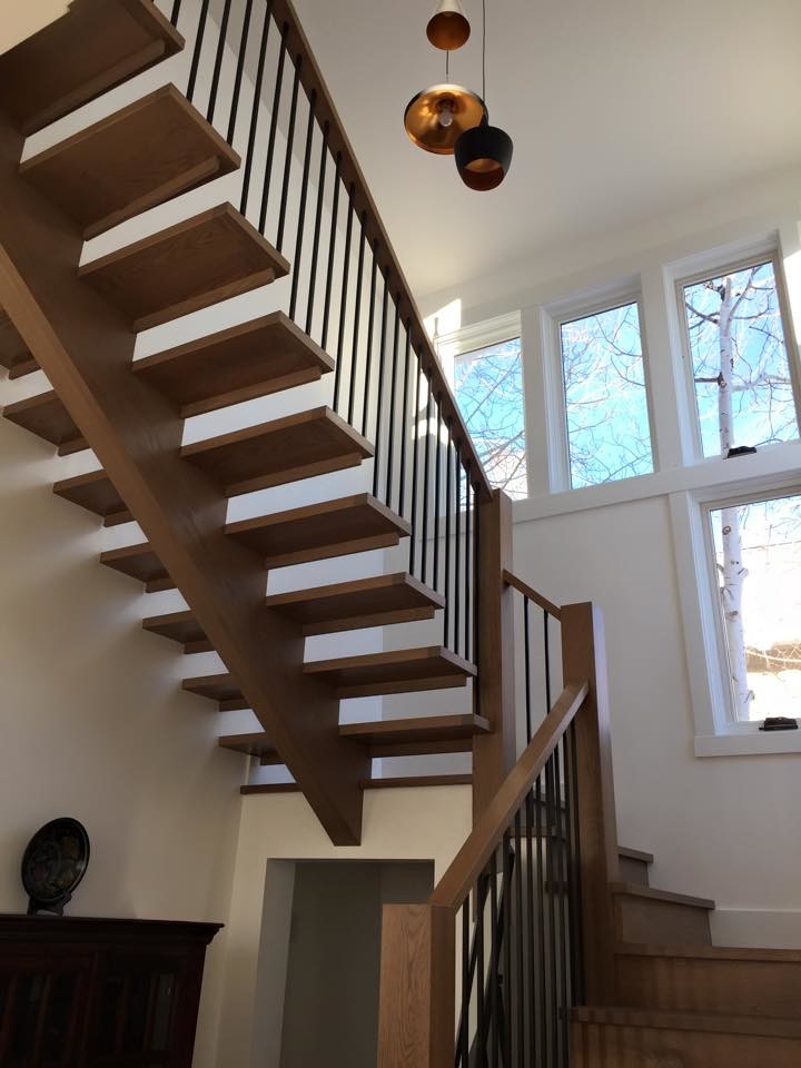Trendy wooden open staircase photo in Denver