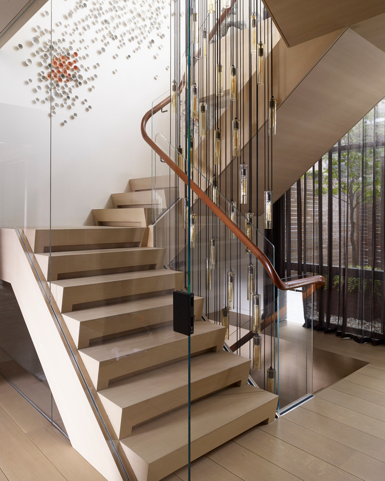 Contemporary wood staircase in New York with wood risers.
