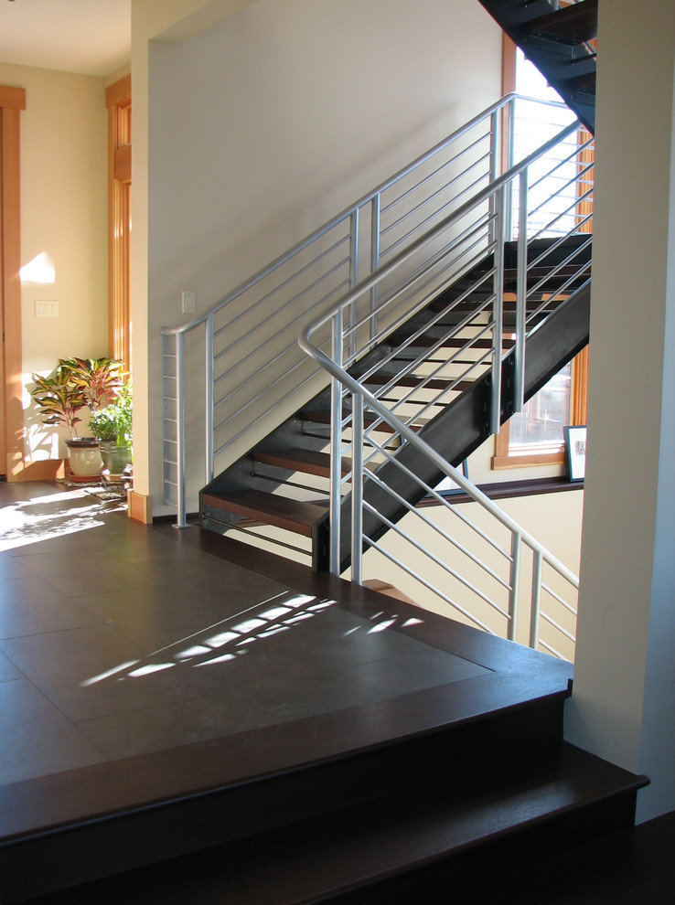 Photo of a contemporary wood staircase in Other with open risers.
