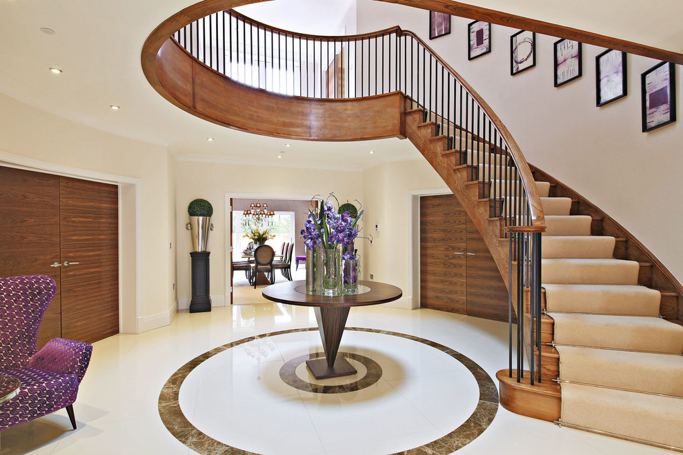 Large contemporary wood curved staircase in London with wood risers.