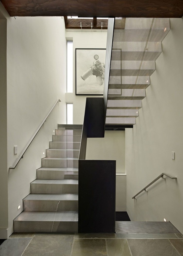 Modelo de escalera en U contemporánea con escalones de metal, contrahuellas de metal y barandilla de metal