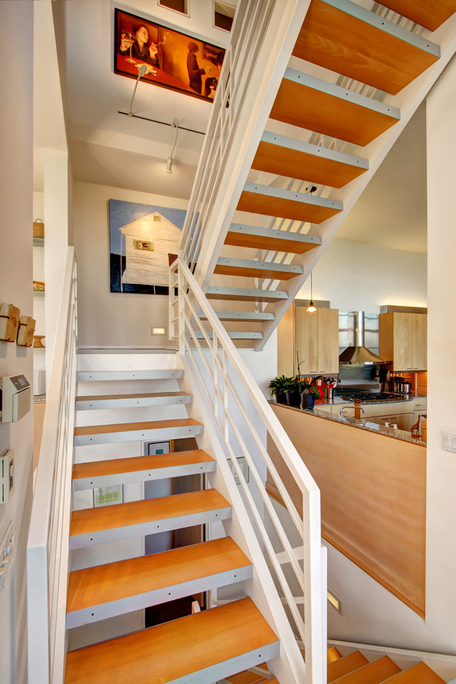 Photo of a contemporary wood staircase in Seattle with open risers.