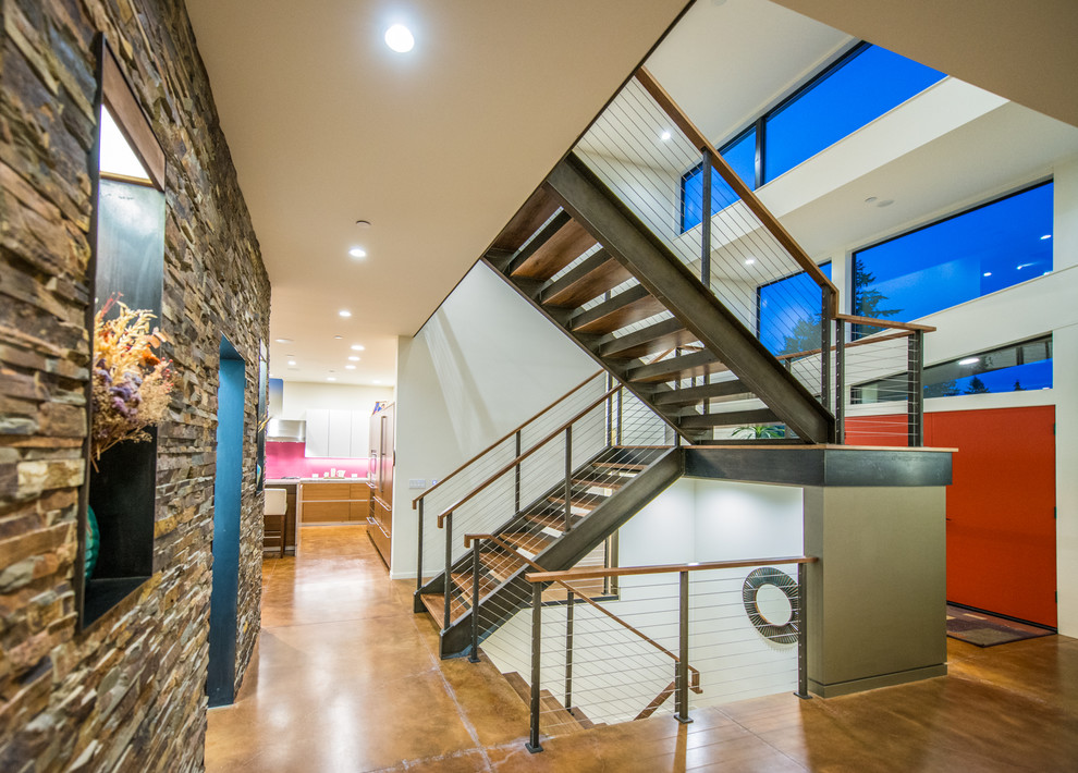 Photo of a contemporary wood u-shaped staircase in Seattle with open risers.