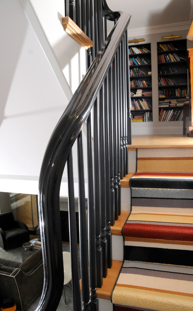 Inspiration for a mid-sized timeless wooden curved staircase remodel in Toronto with painted risers