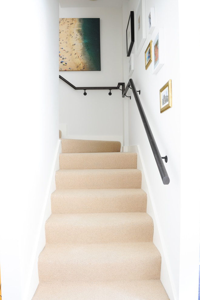 Small midcentury carpeted l-shaped staircase in Vancouver with carpeted risers.
