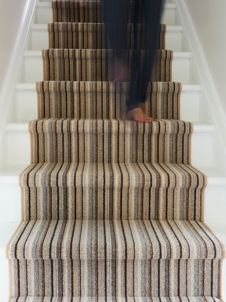 Design ideas for a traditional carpeted straight staircase in Toronto with painted wood risers.