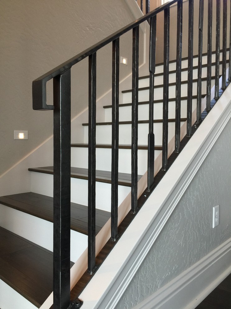 Mid-sized elegant wooden u-shaped metal railing staircase photo in Other with painted risers
