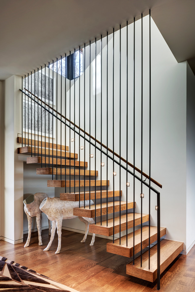 Photo of a medium sized contemporary wood u-shaped staircase in Dallas with wood risers.