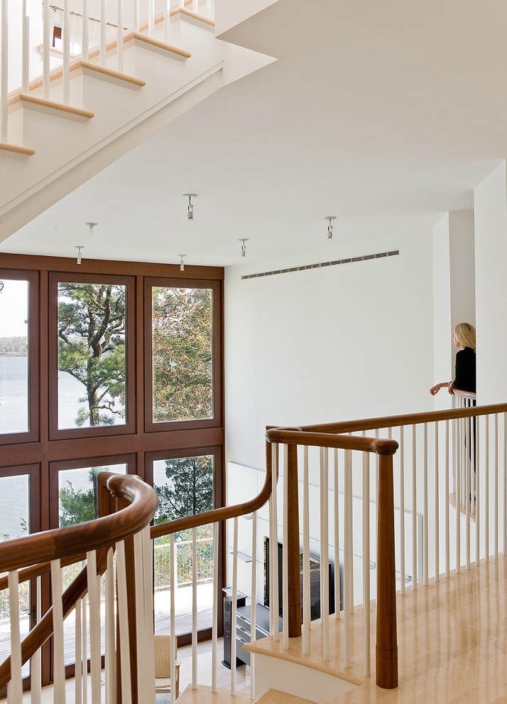Staircase - contemporary wooden spiral staircase idea in Boston with painted risers