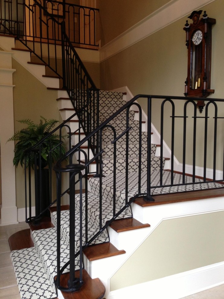 Photo of a medium sized traditional wood l-shaped metal railing staircase in Charleston with painted wood risers.