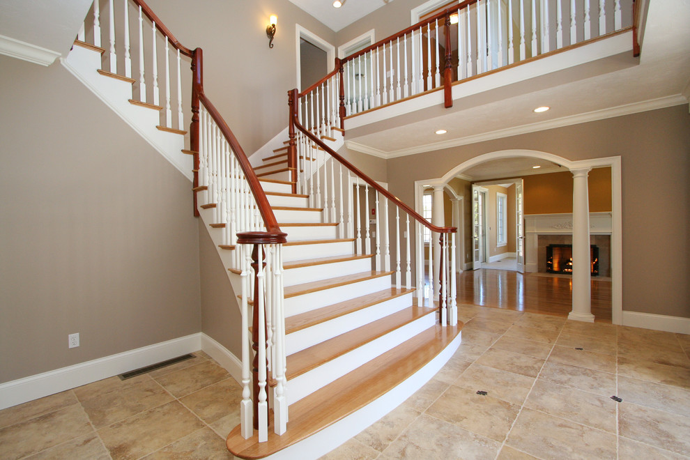 Design ideas for a large classic wood staircase in Boston with wood risers.