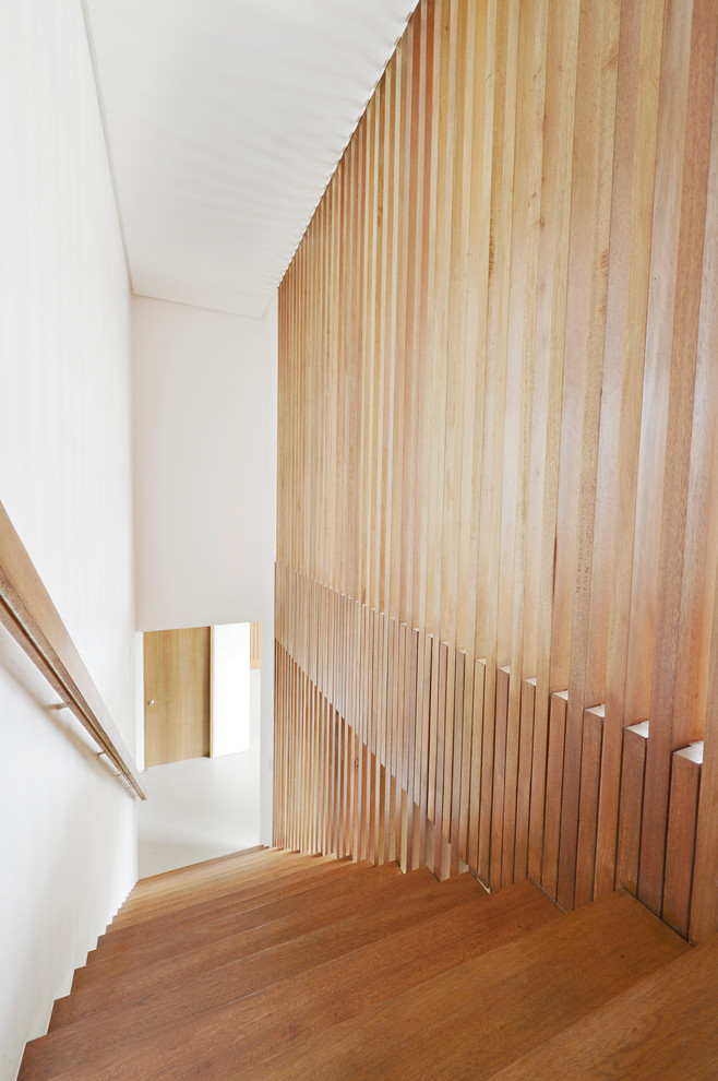 Photo of a medium sized contemporary wood straight wood railing staircase in New York with wood risers.