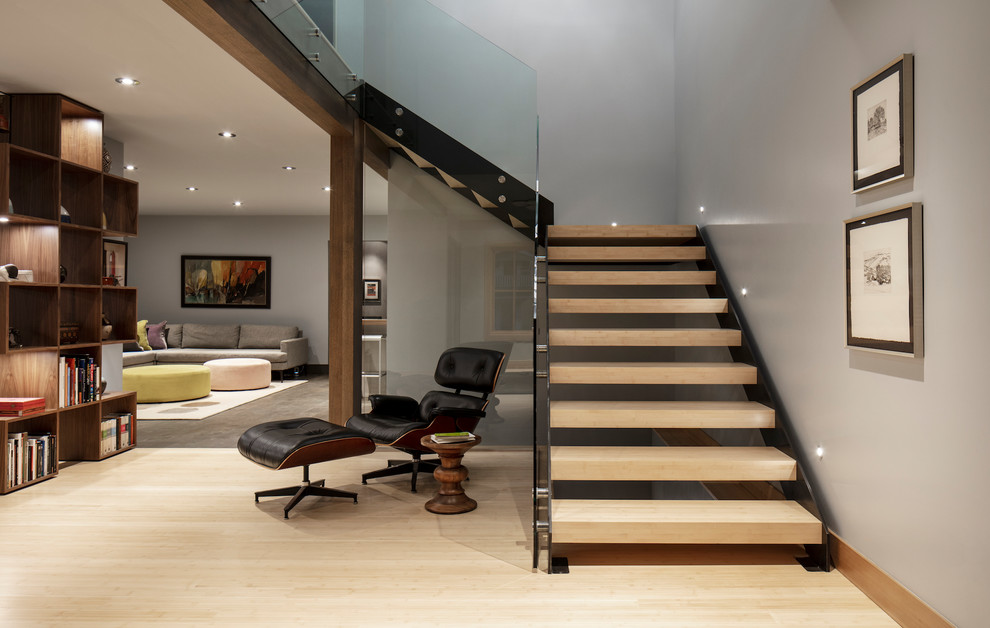 Huge trendy wooden l-shaped open and glass railing staircase photo in Salt Lake City