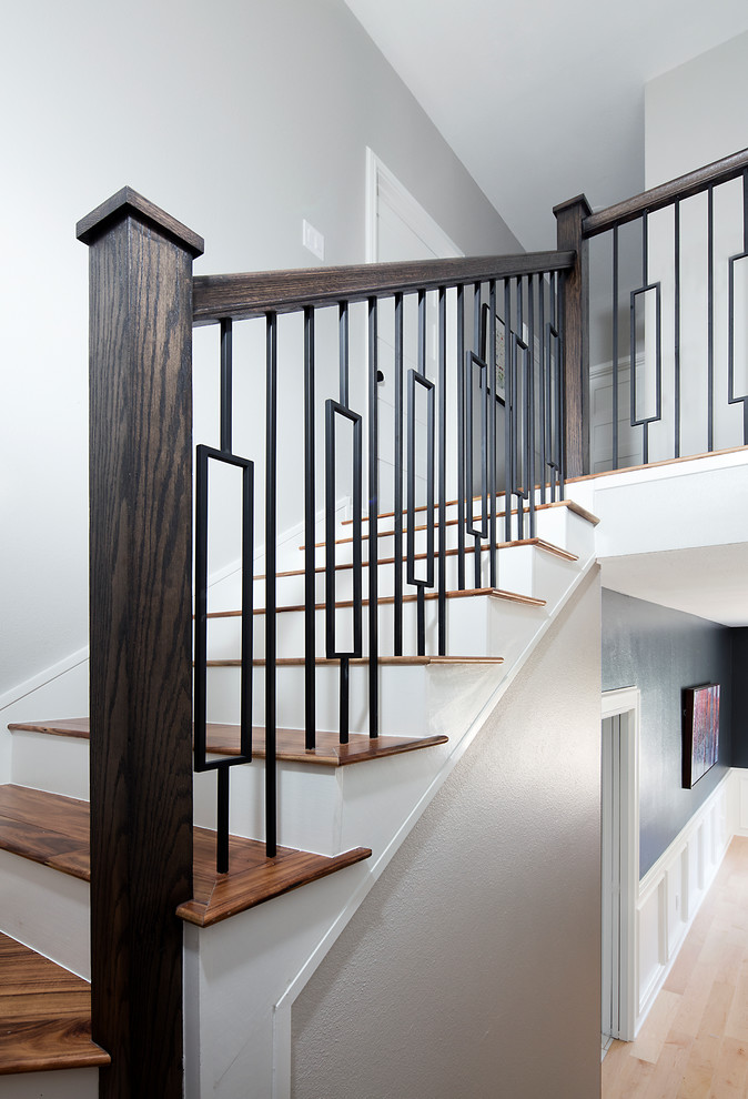 На фото: лестница на больцах, среднего размера в стиле неоклассика (современная классика) с деревянными ступенями, крашенными деревянными подступенками и перилами из смешанных материалов