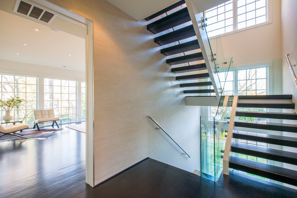 Photo of a large modern wood u-shaped staircase in DC Metro with open risers.