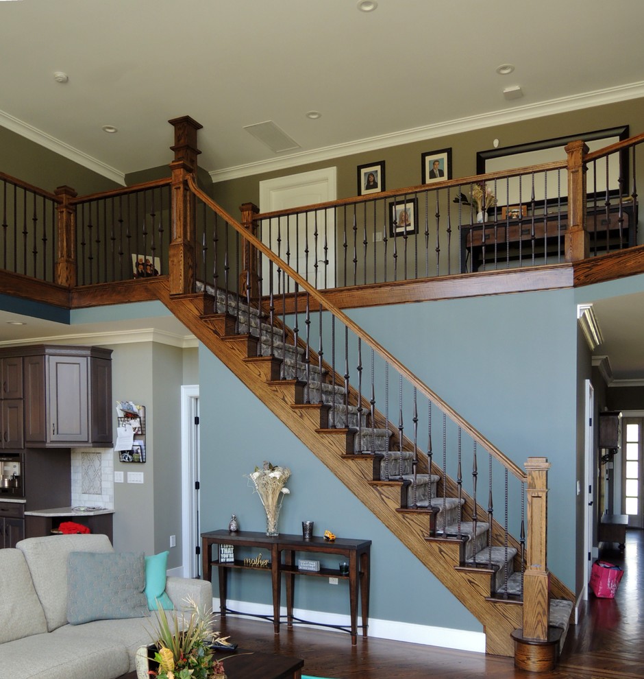 Inspiration for a large traditional wood straight mixed railing staircase in New York with wood risers.