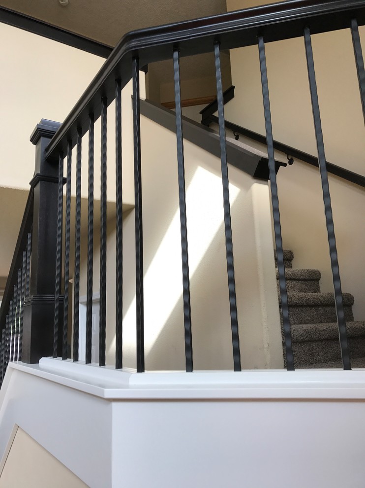 This is an example of a medium sized traditional carpeted straight wood railing staircase in Portland with carpeted risers.