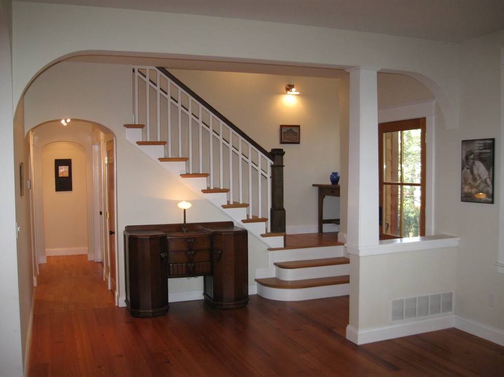Ejemplo de escalera en L de estilo americano de tamaño medio con escalones de madera y contrahuellas de madera