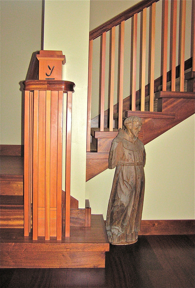This is an example of an expansive classic wood l-shaped staircase in San Luis Obispo with wood risers.