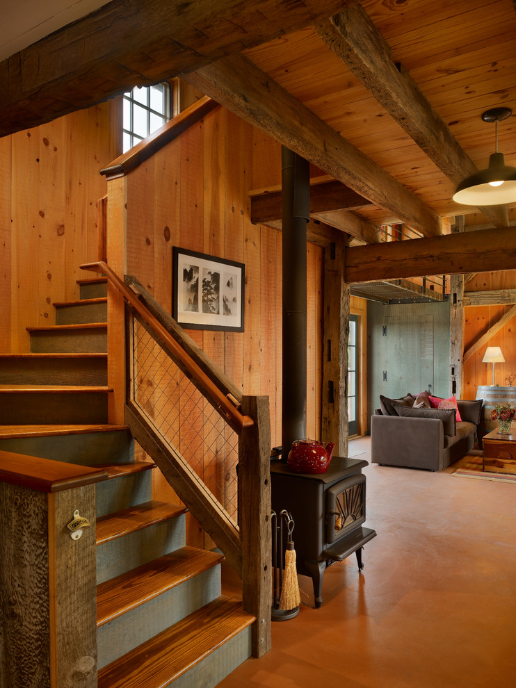 Rustic wood l-shaped staircase in New York with feature lighting.