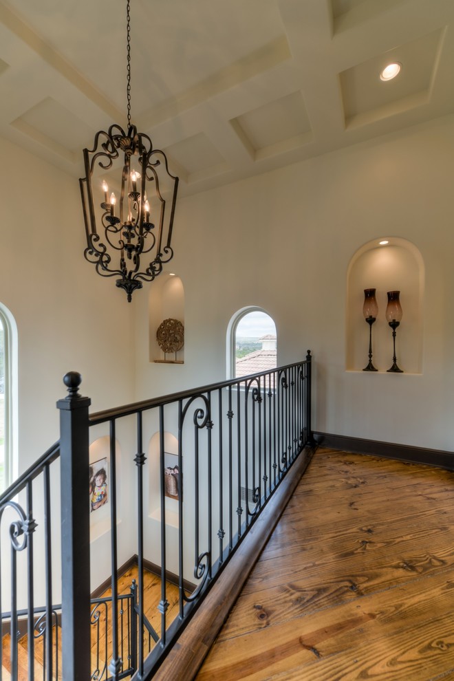Photo of a large mediterranean wood l-shaped staircase in Austin with metal risers.
