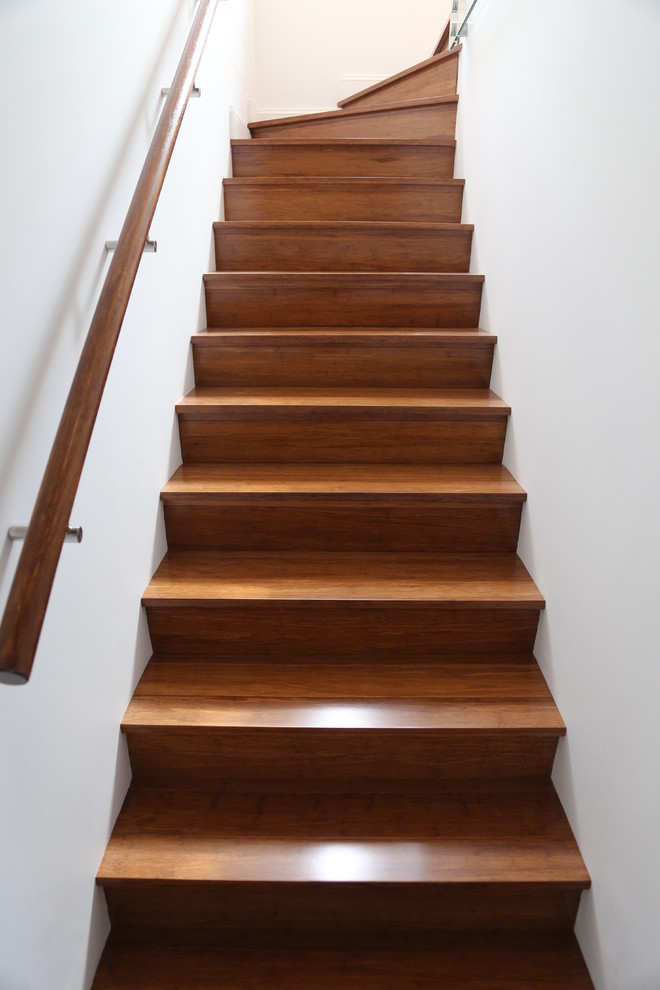 Inspiration for a large modern wooden l-shaped staircase remodel in Sydney with wooden risers