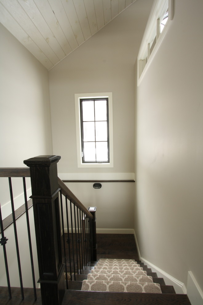 Photo of a medium sized traditional carpeted u-shaped staircase in Toronto with wood risers.