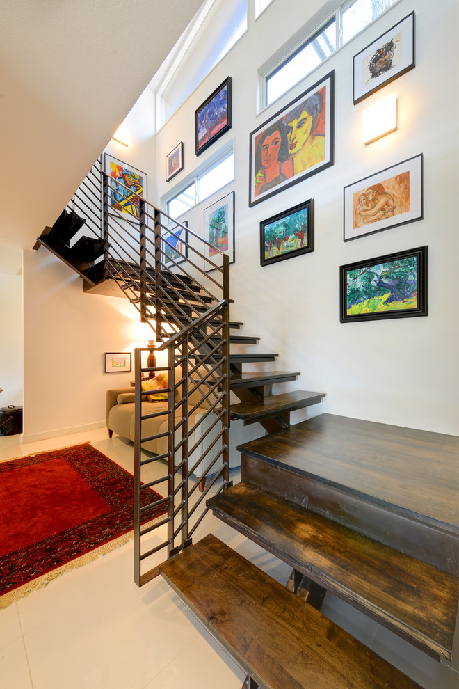 Inspiration for a mid-century modern wooden open staircase remodel in Austin